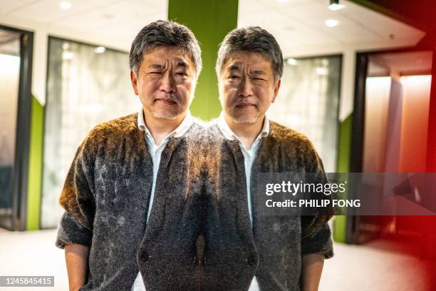 In this picture taken on December 9 Japanese director Hirokazu Kore-eda poses during a photo session following an interview with AFP in Tokyo. -...