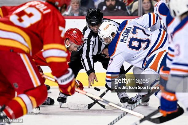 Calgary Flames Center Elias Lindholm and Edmonton Oilers Center Connor McDavid take a face-off during the third period of an NHL game between the...