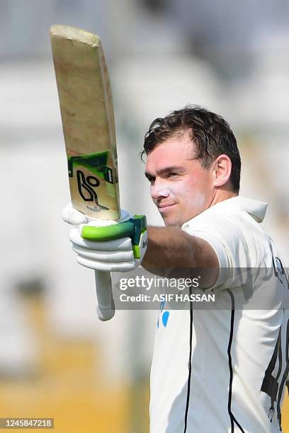 New Zealand's Tom Latham celebrates after scoring a century during the third day of the first Test match between Pakistan and New Zealand at the...
