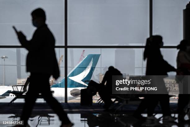 Passengers walk at the Hong Kong International Airport in Hong Kong on December 28, 2022.