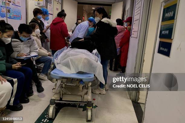 This picture shows a dead person on a gurney at Tianjin First Center Hospital in Tianjin on December 28, 2022. - Cities across China have struggled...