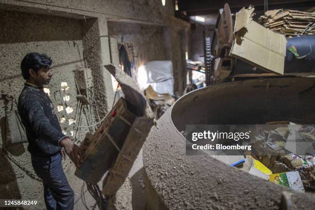 An operator supervises raw materials in the pulping machinery at Bindlas Duplux Ltd., paper mill in Muzaffarnagar District, Uttar Pradesh, India, on...