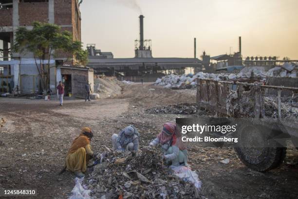 Workers collect residual plastic and other impurities at Bindlas Duplux Ltd., paper mill in Muzaffarnagar District, Uttar Pradesh, India, on...