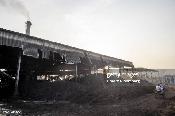Piles of coal next to a steam boiler unit at Bindlas Duplux Ltd., paper mill in Muzaffarnagar District, Uttar Pradesh, India, on Saturday, Nov. 19,...