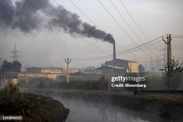 Paper mills spew smoke in Muzaffarnagar District, Uttar Pradesh, India, on Saturday, Nov. 19, 2022. Plastic wrappers and parcels that start off in...