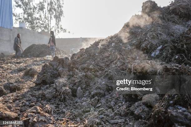 Residue ash containing semi-burnt plastic bags from a steam boiler of a paper mill arrives at a scrap yard in Muzaffarnagar District, Uttar Pradesh,...