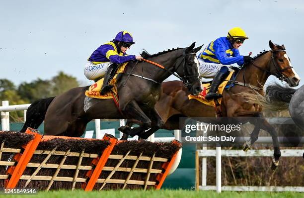 Dublin , Ireland - 28 December 2022; Deep Cave, left, with Rachael Blackmore up, jumps the second on their way to winning the Savills Maiden Hurdle...
