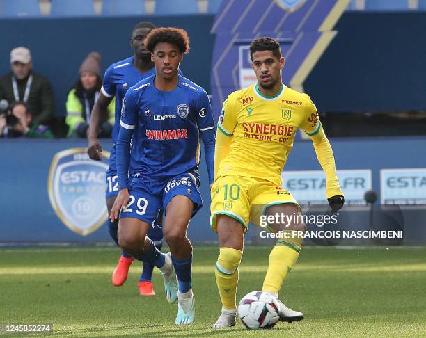 Nantes' French midfielder Ludovic Blas plays the ball next to Troyes' French forward Wilson Odobert during the French L1 football match between ES...