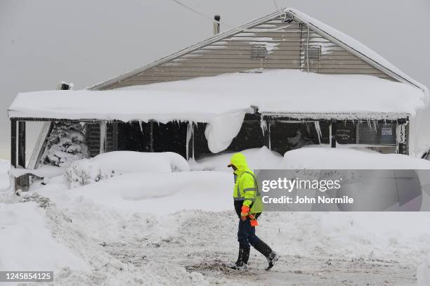 Jack Stanton checks his ice encrusted home after being battered with waves from Lake Erie along Hoover Beach on December 27, 2022 in Hamburg, New...