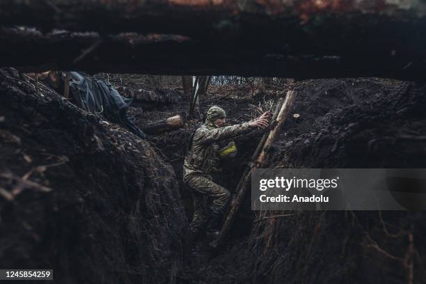 Ukrainian soldier is seen in a trench on the frontline in Donbass, Ukraine on December 28, 2022.