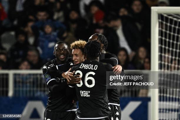 Monaco's French midfielder Eliesse Ben Seghir celebrates with his teammates after scoring a second goal during the French L1 football match between...