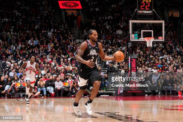 Kawhi Leonard of the LA Clippers dribble the ball against the Toronto Raptors on December 27, 2022 at the Scotiabank Arena in Toronto, Ontario,...