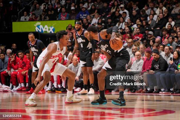 Scottie Barnes of the Toronto Raptors plays defense on Kawhi Leonard of the LA Clippers on December 27, 2022 at the Scotiabank Arena in Toronto,...