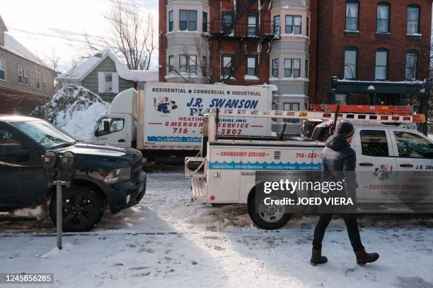 Plumbing crews tackle burst pipes on Bryant Street in Buffalo, New York on December 28, 2022. - The monster storm that killed dozens in the US over...