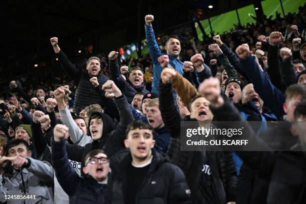 Leeds fans cheer and sing ahead of the English Premier League football match between Leeds United and Manchester City at Elland Road in Leeds,...