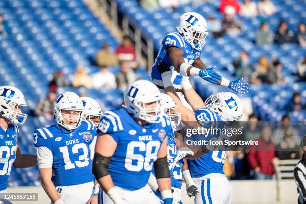 Duke Blue Devils offensive lineman Graham Barton lifts Duke Blue Devils running back Jaquez Moore in the air after scoring a touchdown during the...