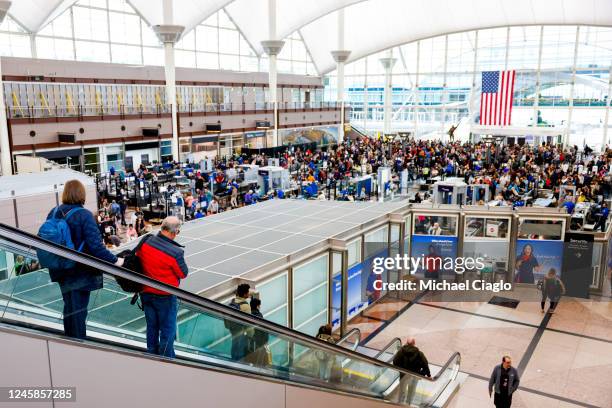 Travelers head to the security checkpoint at Denver International Airport on December 28, 2022 in Denver, Colorado. More than 15,000 flights have...