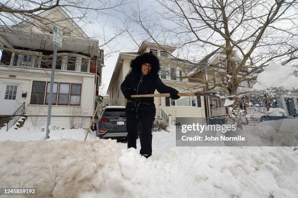 Elizabeth Maymi clears her driveway along South Park Avenue on December 28, 2022 in Buffalo, New York. The historic Winter Storm Elliott dumped up to...