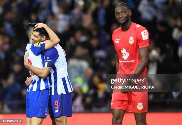 Porto's Canadian midfielder Stephen Eustaquio and FC Porto's Iranian forward Mehdi Taremi celebrate Arouca's English defender Jerome Opoku's owngoal...