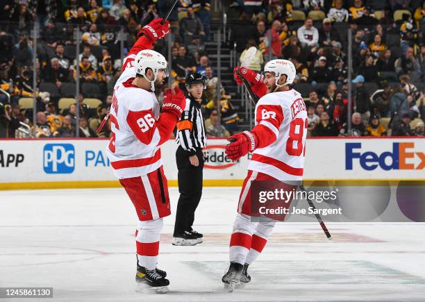 Jake Walman of the Detroit Red Wings celebrates his overtime winning goal against the Pittsburgh Penguins at PPG PAINTS Arena on December 28, 2022 in...