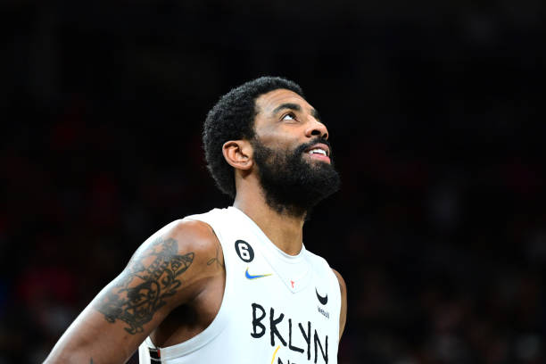 Kyrie Irving of the Brooklyn Nets looks on during the game against the Atlanta Hawks on December 28, 2022 at State Farm Arena in Atlanta, Georgia....