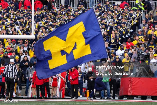 Michigan Wolverines cheerleader runs the Michigan banner thru the end zone after a Wolverines touchdown during the fourth quarter of the college...