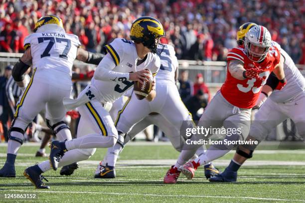 Michigan Wolverines quarterback J.J. McCarthy rolls out of the pocket during the third quarter of the college football game between the Michigan...
