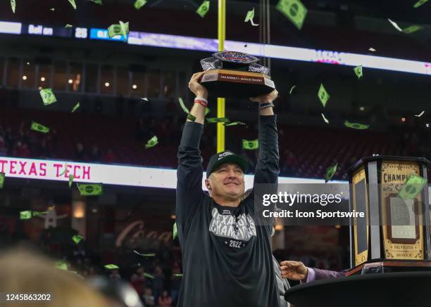 Texas Tech Red Raiders head coach Joey McGuire holds up the Robert C. McNair trophy during the TaxAct Texas Bowl between the Texas Tech Red Raiders...