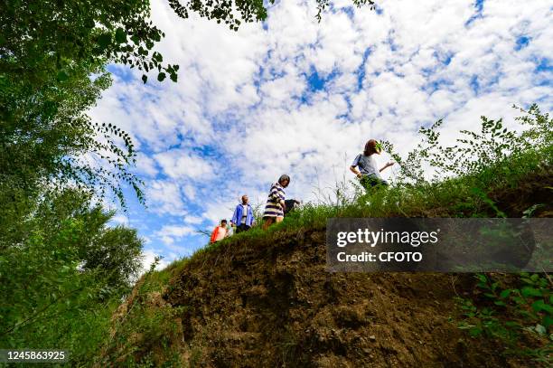 Tourists walk at the ruins of the city wall of Shangjing Bohai Sea Town in Liaoning Province, Chifeng city, Inner Mongolia Autonomous region, China,...