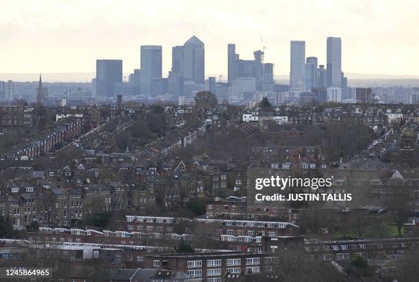 View of residential properties with the skyline of London's financial district seen behind taken from Alexandra Palace in London on December 29, 2022.