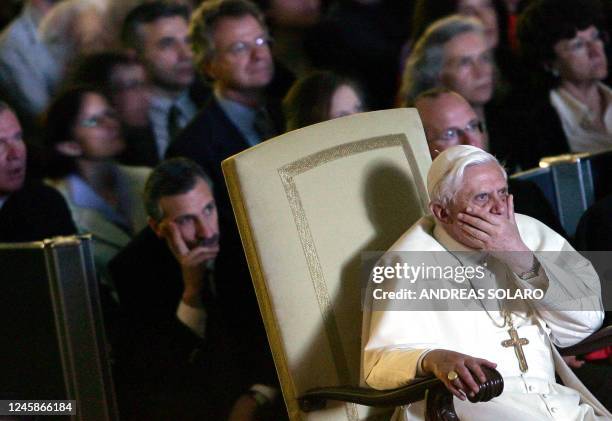 Pope Benedict XVI reacts during the movie on the life of the late Pope John Paul II "Un Papa rimasto uomo" , at Aula Nervi at the Vatican, 30 March...