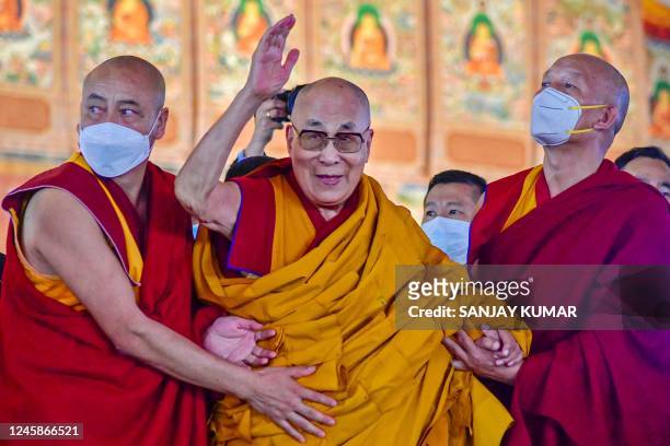 Tibetan spiritual leader Dalai Lama waves during his first day of teaching session at the Kalachakra Ground in Bodhgaya on December 29, 2022.