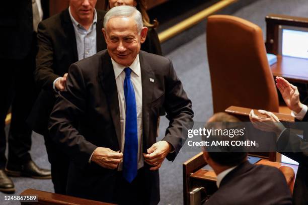 Israel's Prime Minister Benjamin Netanyahu reacts during the swearing in session of his new government at the Knesset in Jerusalem, on December 29,...