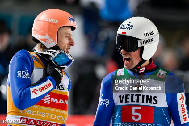 Dawid Kubacki and Piotr Zyla both of Poland react in the finish area after the second round of the Individual HS137 at the Four Hills Tournament Men...