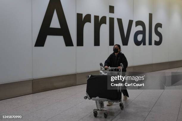 Woman arrives at Heathrow airport on a flight from Shanghai on December 29, 2022 in London, United Kingdom. Following China's announcement earlier...