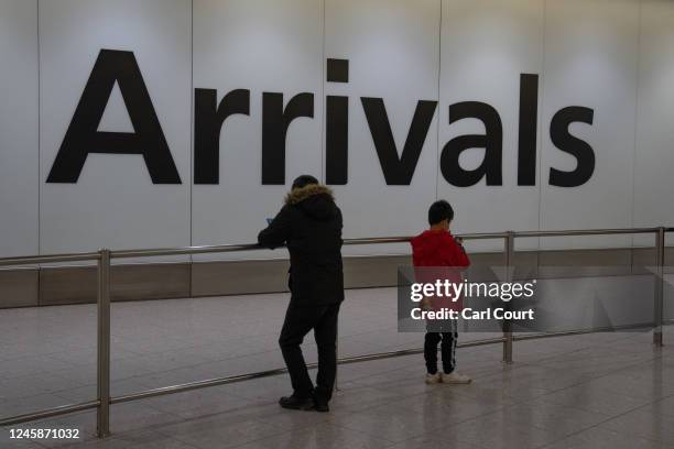 People wait at Heathrow airport ahead of the arrival of a flight from Shanghai on December 29, 2022 in London, United Kingdom. Following China's...