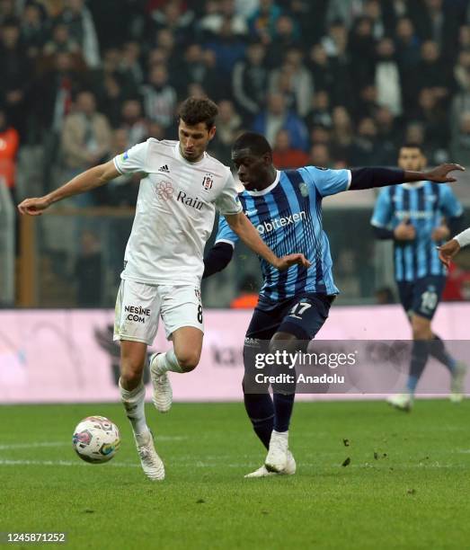 Salih Ucan of Besiktas in action against Ndiaye of Adana Demirspor during the Turkish Super Lig week 16 soccer match between Besiktas and Adana...