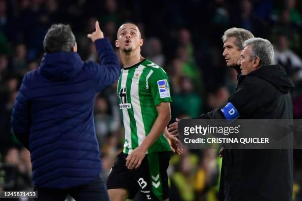 Real Betis' Italian defender Luiz Felipe talks to Athletic Bilbao's Spanish coach Ernesto Valverde as he leaves the pitch after getting a red card...