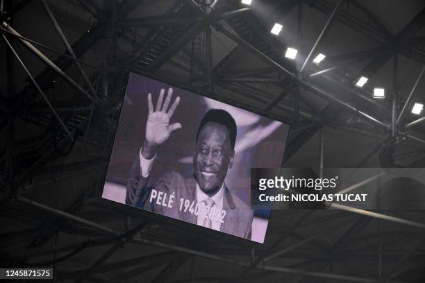 Photograph of Brazilian football legend Pele is displayed on a giant screen prior to the French L1 football match between Olympique de Marseille and...