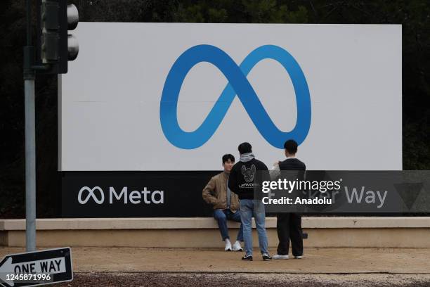 Visitors take photos in front of the Meta sign at its headquarters in Menlo Park, California, United States on December 29, 2022.