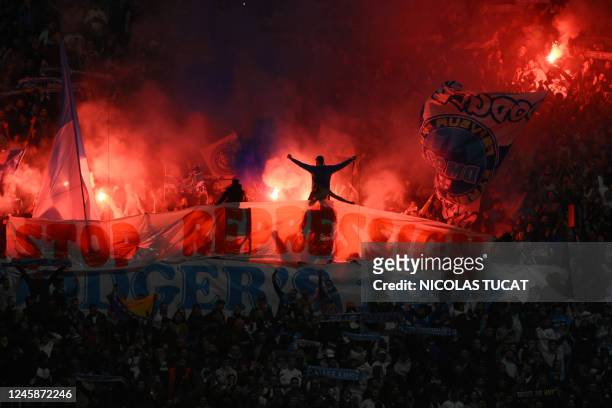 Marseille's supporters light flares during the French L1 football match between Olympique de Marseille and Toulouse FC at the Velodrome stadium in...