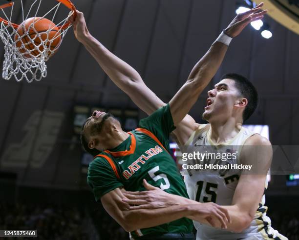 Zach Edey of the Purdue Boilermakers dunks the ball against Jaylen Bates of the Florida A&M Rattlers during the second half at Mackey Arena on...