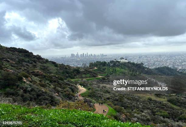 The skyline of Los Angeles is seen past Griffith Observatory in Los Angeles, California, on December 29, 2022.