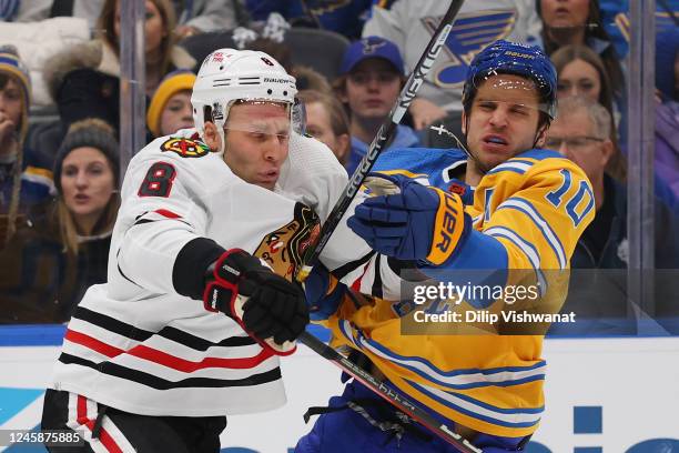 Jack Johnson of the Chicago Blackhawks defends against Brayden Schenn of the St. Louis Blues in the first period at the Enterprise Center on December...