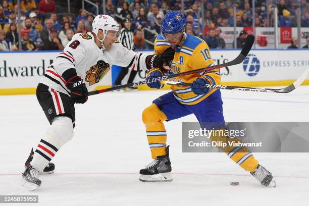 Jack Johnson of the Chicago Blackhawks defends against Brayden Schenn of the St. Louis Blues in the first period at the Enterprise Center on December...