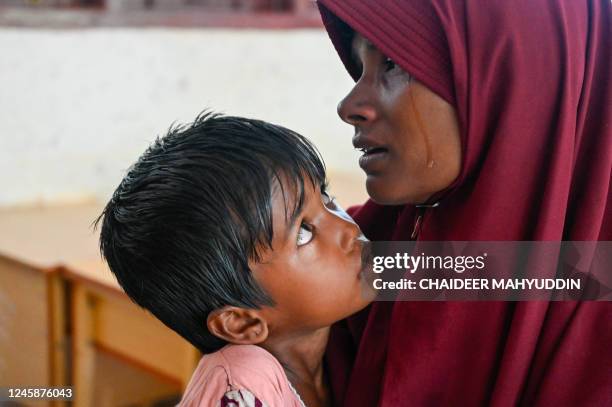 Rohingya refugee cries while registering their identities with Indonesian immigration officers at a temporary shelter in Laweueng, Aceh province on...