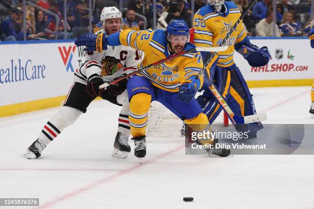 Justin Faulk of the St. Louis Blues fights Jonathan Toews of the Chicago Blackhawks for control of the puck in the second period at the Enterprise...