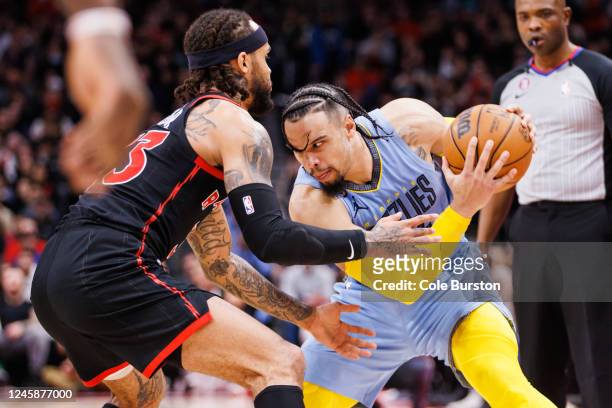 Dillon Brooks of the Memphis Grizzlies is defended by Gary Trent Jr. #33 of the Toronto Raptors during the second half of their NBA game at...