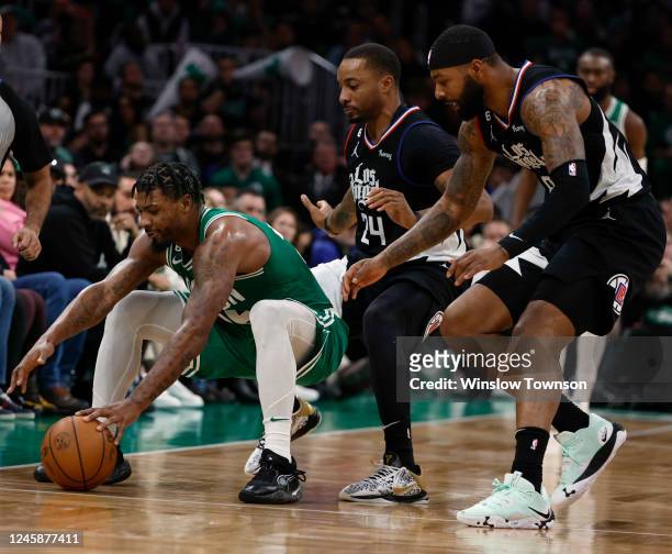 Marcus Smart of the Boston Celtics gathers in a loose ball against Norman Powell and Marcus Morris Sr. Of the Los Angeles Clippers during the second...