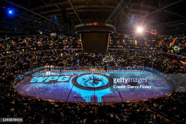 General view of the arena bowl as fans light it up during the on-ice projection show prior to NHL action between the Winnipeg Jets and the Vancouver...